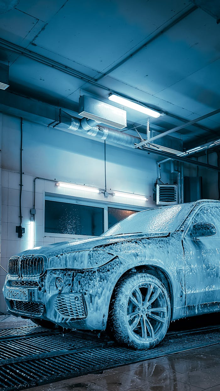The Art of Drawing Readers In: Your attractive post title goes here Luxury SUV covered in foam inside a modern car wash station enhanced by blue lighting.